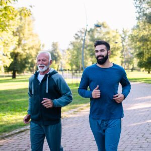 Happy,Father,And,Son,Jogging,Together,Outdoors,In,Park.