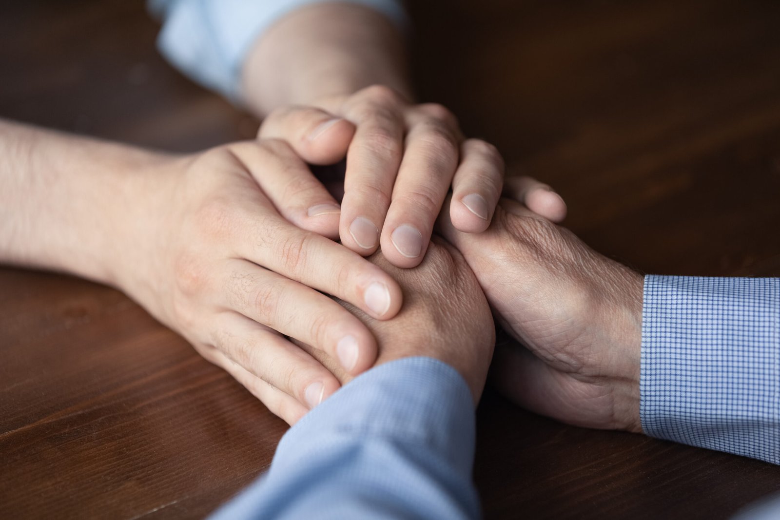 Young,Man,Holding,Hands,Of,Elderly,Father,Close,Up.,Grown
